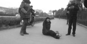 鄭大姐坐在地上，警方趕到進行施救。（視頻截圖由警方提供）