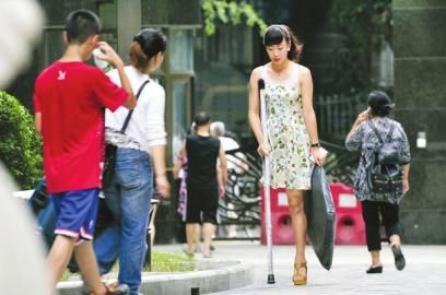 7月11日，阿依穿著高跟鞋在小區拿快遞。