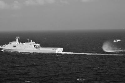 11日，抵達(dá)馬航飛機(jī)失聯(lián)海區(qū)的海軍井岡山艦與艦載直升機(jī)協(xié)同展開立體搜救行動。新華社發(fā)