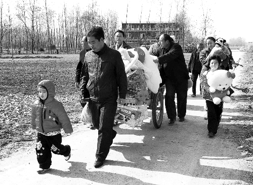 姐（左一）弟（右一護士懷中男嬰）返鄉(xiāng)，愛心捐贈滿滿一架子車。